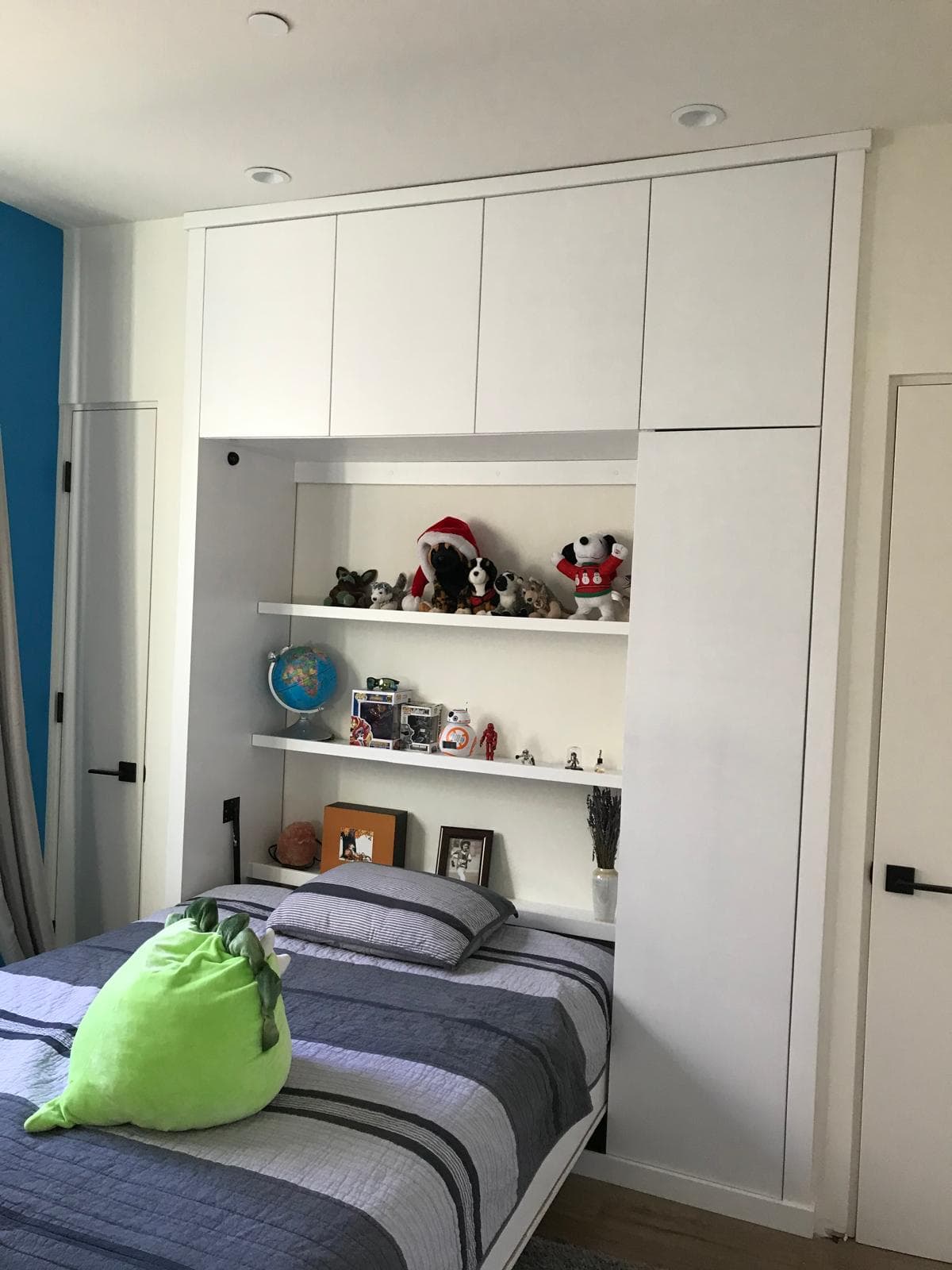Custom built-in wall unit with shelving in a modern bedroom